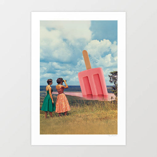 A View to Chill Popsicle Panorama surreal art print — two women in 1950s summer dresses on a grassy hilltop, one in green one in pink floral, looking out over a vast landscape where a giant pink strawberry ice lolly on a wooden stick stands melting into the valley below, dramatic cloudy blue sky, retro surreal summer wall art for kitchens, beach houses and ice cream parlour interiors
