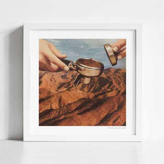 Barista Coffee County art print framed lifestyle view — surreal desert landscape coffee art showing barista hands tamping espresso over red rock canyon terrain, unique coffee wall art for home kitchens specialty coffee bars diners and unique gift for coffee lovers