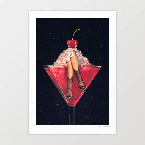 Cherry Cowgirl Margarita surreal art print — two tanned legs wearing brown leather cowboy boots sticking up from crushed ice inside a deep crimson red martini cocktail glass topped with a glossy maraschino cherry, against a deep black starry night sky background, cowgirl core western bar art for bachelorette parties Nashville lovers and coquette interiors