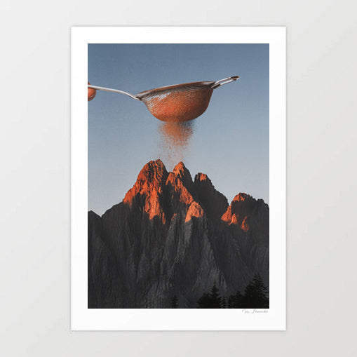 Cocoa Dusk surreal collage artwork — a hand holding a kitchen sieve dusting fine cocoa powder over dramatic jagged alpine mountain peaks bathed in deep amber golden hour sunset light against a cool blue grey sky, culinary surrealism landscape art for cafes chocolatiers dessert restaurants and chocolate lover interiors