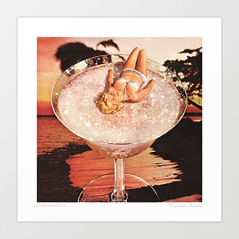 Surreal retro art print —1950s pin-up blonde in white bikini reclining in a giant sparkling margarita glass against a tropical palm tree sunset, vintage cocktail bar wall art by Vertigo Artography